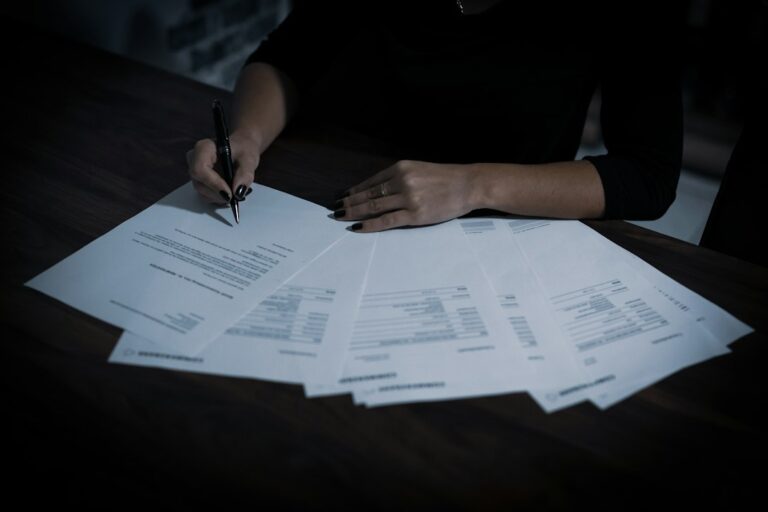 A person reviewing and signing insurance paperwork