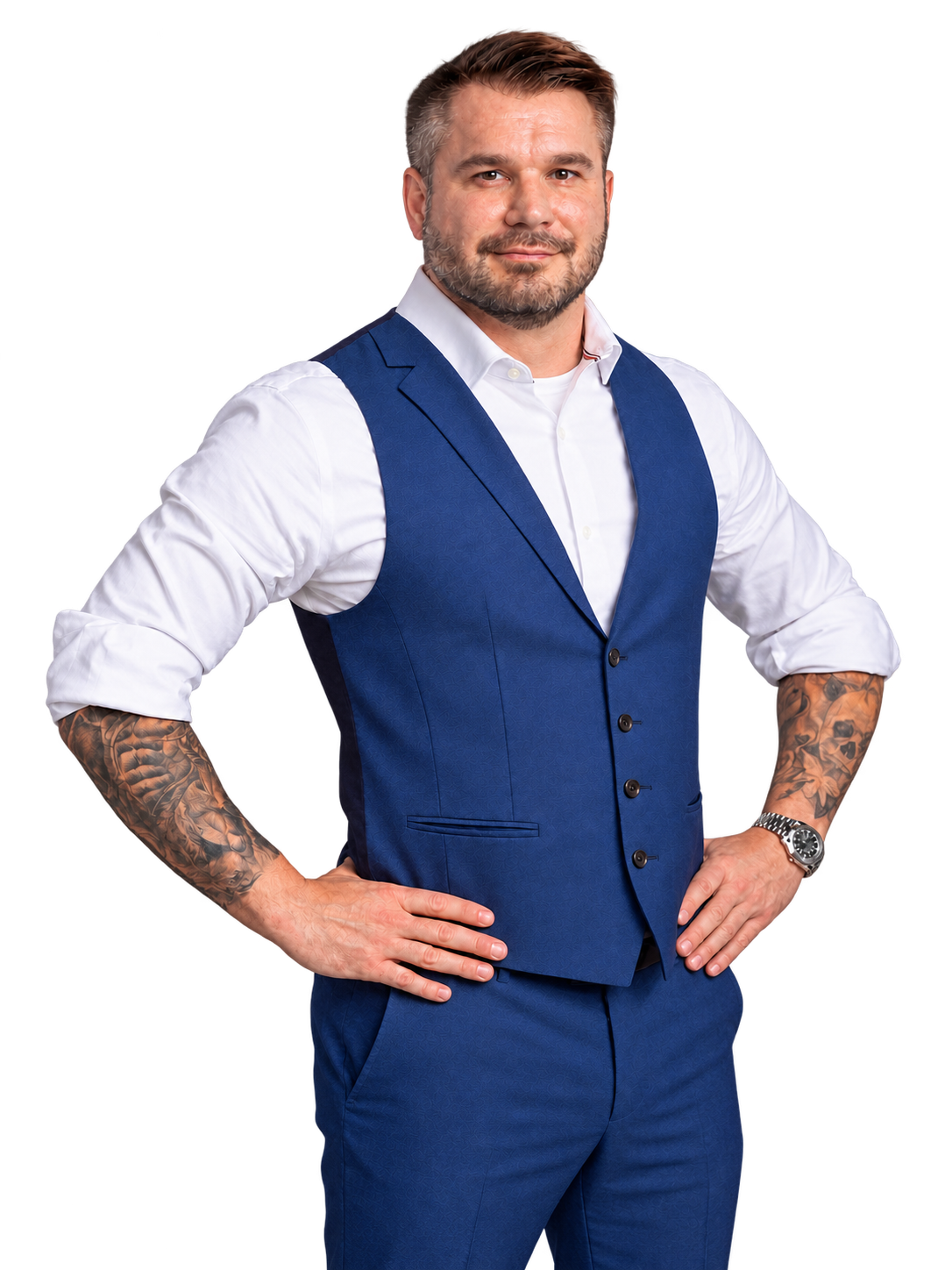 Brian Crockett in a blue vest, with both elbows and forearms visible