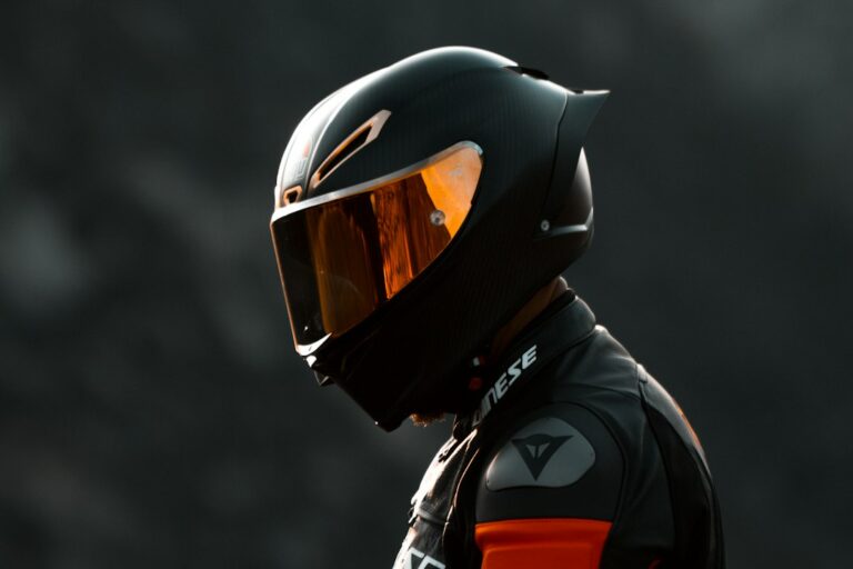 Motorcycle rider wearing a protective helmet